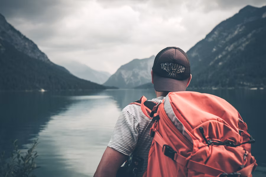 Backpacker overlooking a mountain lake